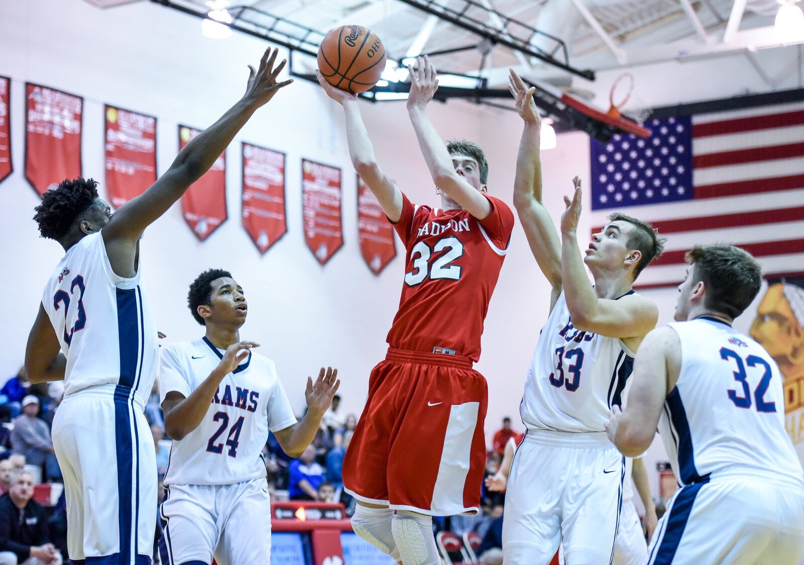 Madison’s Grant Whisman cuts through Miami Valley defenders Lennox Roberts (23), Marc Williams (24), Casey Gossett (33) and Mark Kokoropoulos during Thursday night’s Brian Cook Classic at Madison. NICK GRAHAM/STAFF