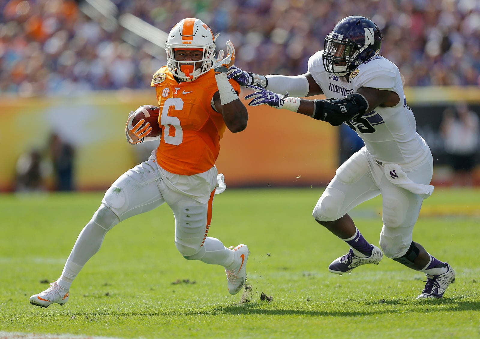 TAMPA, FL - JANUARY 1: Alvin Kamara #6 of the Tennessee Volunteers avoids a tackle by Drew Smith #55 of the Northwestern Wildcats during the first half of the Outback Bowl at Raymond James Stadium on January 1, 2016 in Tampa, Florida. (Photo by Mike Carlson/Getty Images)