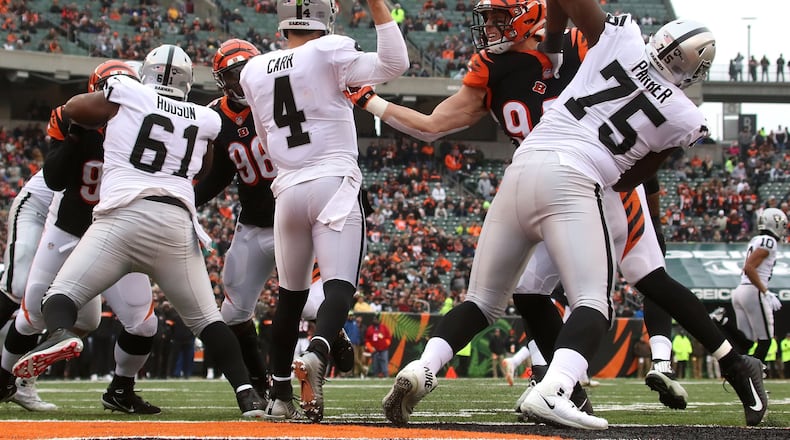 CINCINNATI, OH - DECEMBER 16: Sam Hubbard #94 of the Cincinnati Bengals fights through a block by Brandon Parker #75 of the Oakland Raiders to knock down an attempted pass by Derek Carr #4 during the first quarter at Paul Brown Stadium on December 16, 2018 in Cincinnati, Ohio. (Photo by John Grieshop/Getty Images)