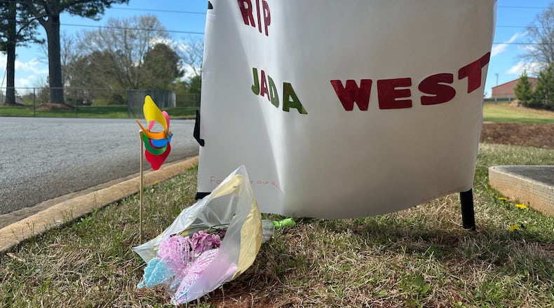 A paper sign left in memory of Jada West stands in her neighborhood in Villa Rica, Ga., Wednesday, March 11, 2026. (AP Photo/Kate Brumback)