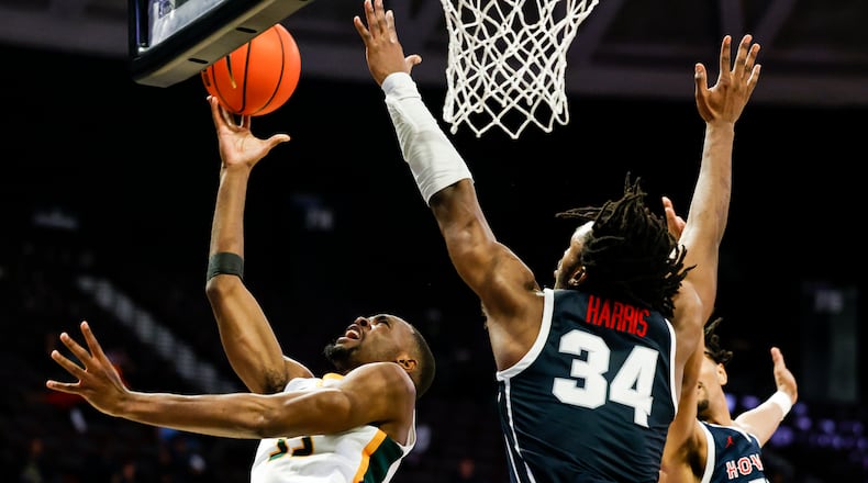Norfolk State's Jack Doumbia (33) shoots against Howard's Bryce Harris (34) during an NCAA college basketball game in Mid-Eastern Athletic Conference men's tournament semifinals Friday, March 15, 2024, in Norfolk, Va. (Billy Schuerman/The Virginian-Pilot via AP)