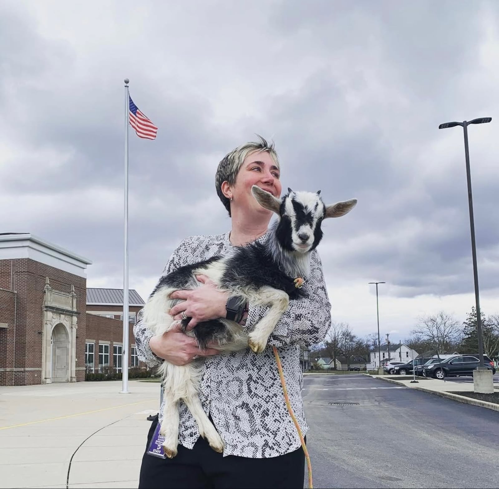 Charity Goode holds a goat in front of Rosa Parks Elementary, where she serves the Prek-6th school as principal. CONTRIBUTED