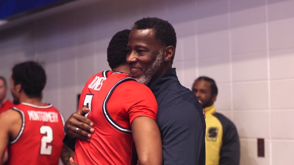 Dayton's Anthony Grant, right, hugs Keonte Jones after a victory against George Washington on Friday, Feb. 27, 2026, at the Charles E. Smith Center in Washington, D.C. David Jablonski/Staff