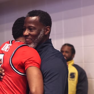 Dayton's Anthony Grant, right, hugs Keonte Jones after a victory against George Washington on Friday, Feb. 27, 2026, at the Charles E. Smith Center in Washington, D.C. David Jablonski/Staff