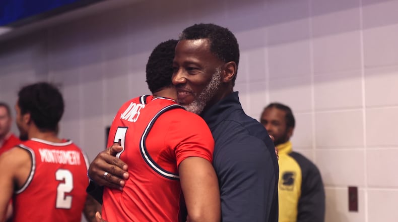 Dayton's Anthony Grant, right, hugs Keonte Jones after a victory against George Washington on Friday, Feb. 27, 2026, at the Charles E. Smith Center in Washington, D.C. David Jablonski/Staff