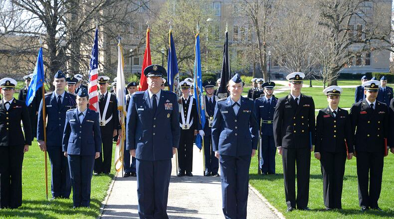 Col. Patrick Miller, 88th Air Base Wing and Wright-Patterson Air Force Base commander, stands at attention along with cadets of Detachment 645 as the Tri-Service Parade concludes April 14 at Ohio State University. The Tri-Service Parade has been a tradition at Ohio State University since 1916 and allows several cadets and midshipmen to receive scholarship awards from generous donors. U.S. AIR FORCE PHOTO/DARRIUS PARKER