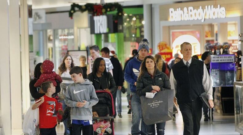 Customers do their holiday shopping at the Dayton Mall. TY GREENLEES/STAFF