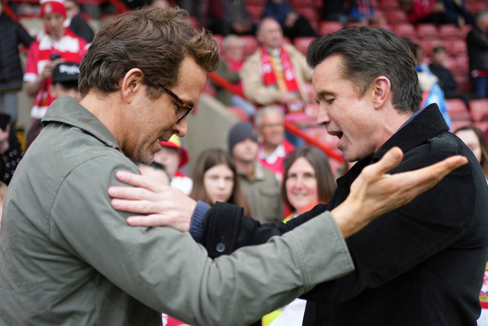 Wrexham co-owners Ryan Reynolds, left, and Rob McElhenney, right, speak before the English League One soccer match between Wrexham and Charlton Athletic at the Racecourse ground in Wrexham, Wales, Saturday, April 26, 2025. (AP Photo/Jon Super)