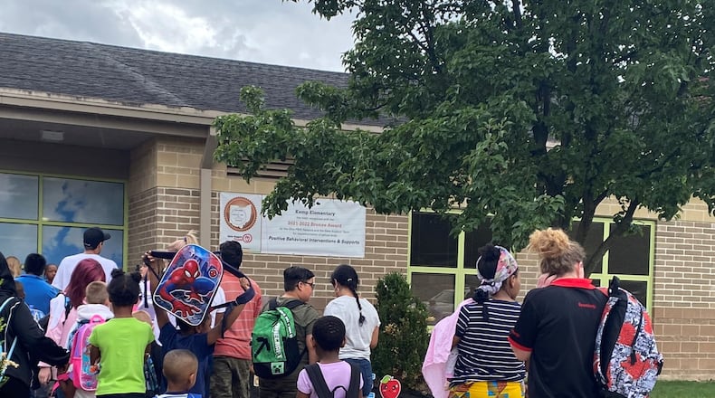 Kids and parents lined up before the first day of school started at Kemp Elementary, part of Dayton Public Schools, on Monday, Aug. 14. Kemp Elementary received 2.5 stars in the 2022-2023 school year report card, higher than the district's overall 2-star rating. Eileen McClory / Staff
