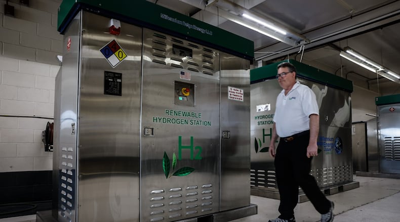 Founder and CEO of Millennium Reign Energy walks by a Renewable Hydrogen Station that is company builds on North Main Street in Dayton Friday July 19, 2024. JIM NOELKER/STAFF