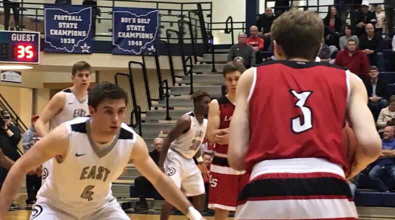 Lakota East’s Jackson See (4) keeps a close eye on La Salle’s Riley Haubner (3) during Friday night’s Division I sectional final at the Hamilton Athletic Center. RICK CASSANO/STAFF