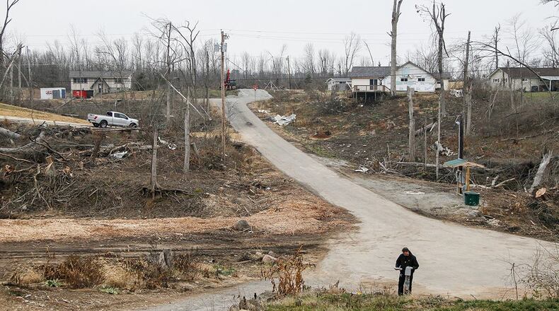 Aaron Krueger could barely see neighbors’ homes from his on Murwood Court in Beavercreek before the Memorial Day tornadoes swept through heavily wooded Grange View Acres. Now some of the homes are gone and others are in plain view. CHRIS STEWART / STAFF