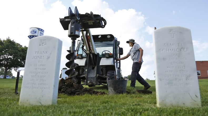 Dayton National Cemetery worker Marcus Jewett prepares a gravesite for interment of cremains. TY GREENLEES / STAFF