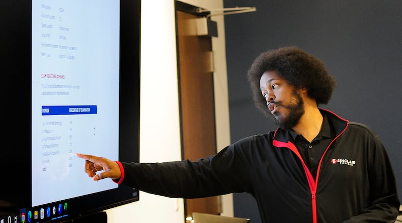 Sinclair Community College instructor, Liban Knight, teaches an Information Technology class Wednesday, Jan. 24, 2024 at the Montgomery County Westown Employment Opportunity Center. MARSHALL GORBY\STAFF