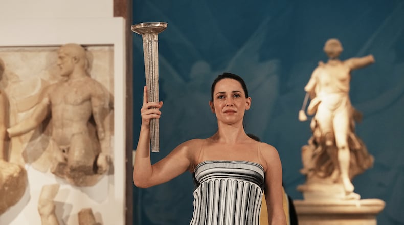 Actress Mary Mina playing the role of high priestess performs during the final rehearsal ahead of the flame lighting for the Milan Cortina 2026 Winter Olympics, at the archaeological museum of Olympia, Greece, Tuesday, Nov. 25, 2025. (AP Photo/Thanassis Stavrakis)