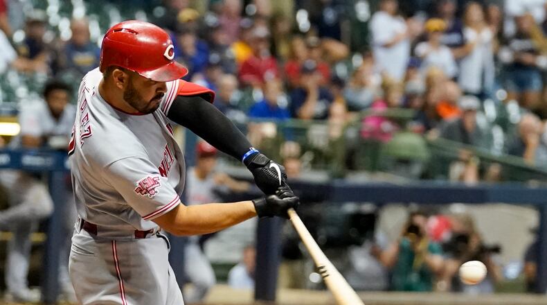 Cincinnati Reds' Eugenio Suarez hits a two-run home run during the ninth inning of a baseball game against the Milwaukee Brewers Monday, July 22, 2019, in Milwaukee. (AP Photo/Morry Gash)