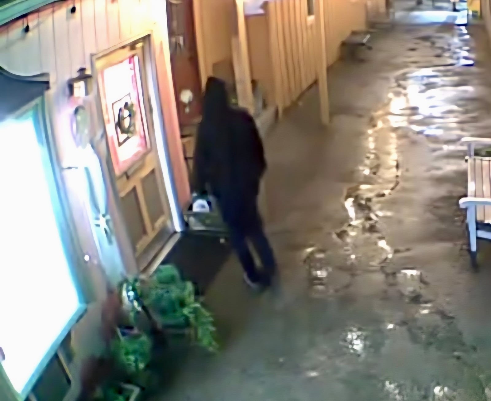 In this screenshot from CCTV footage provided by the business owner, a suspect prepares to smash open the front window of Heaven on Earth Emporium in Yellow Springs early Monday morning. The robbery is the latest in a series of break-ins targeting local businesses in the village. CONTRIBUTED
