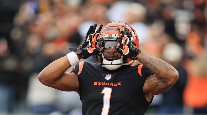 Cincinnati Bengals' Ja'Marr Chase celebrates after a touchdown catch during the first half of an NFL football game against the Cleveland Browns, Sunday, Dec. 11, 2022, in Cincinnati. (AP Photo/Aaron Doster)