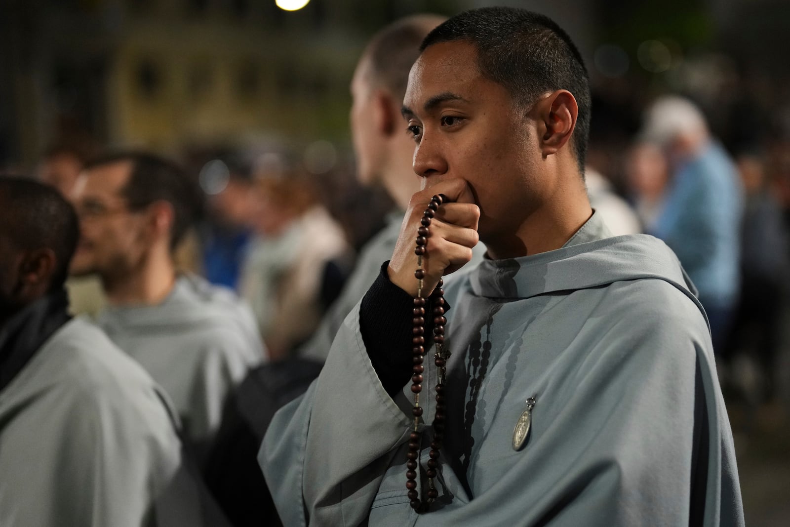 Faithful pray the rosary outside St. Mary Major Basilica, in Rome, Friday, April 25, 2025 (AP Photo/Francisco Seco)