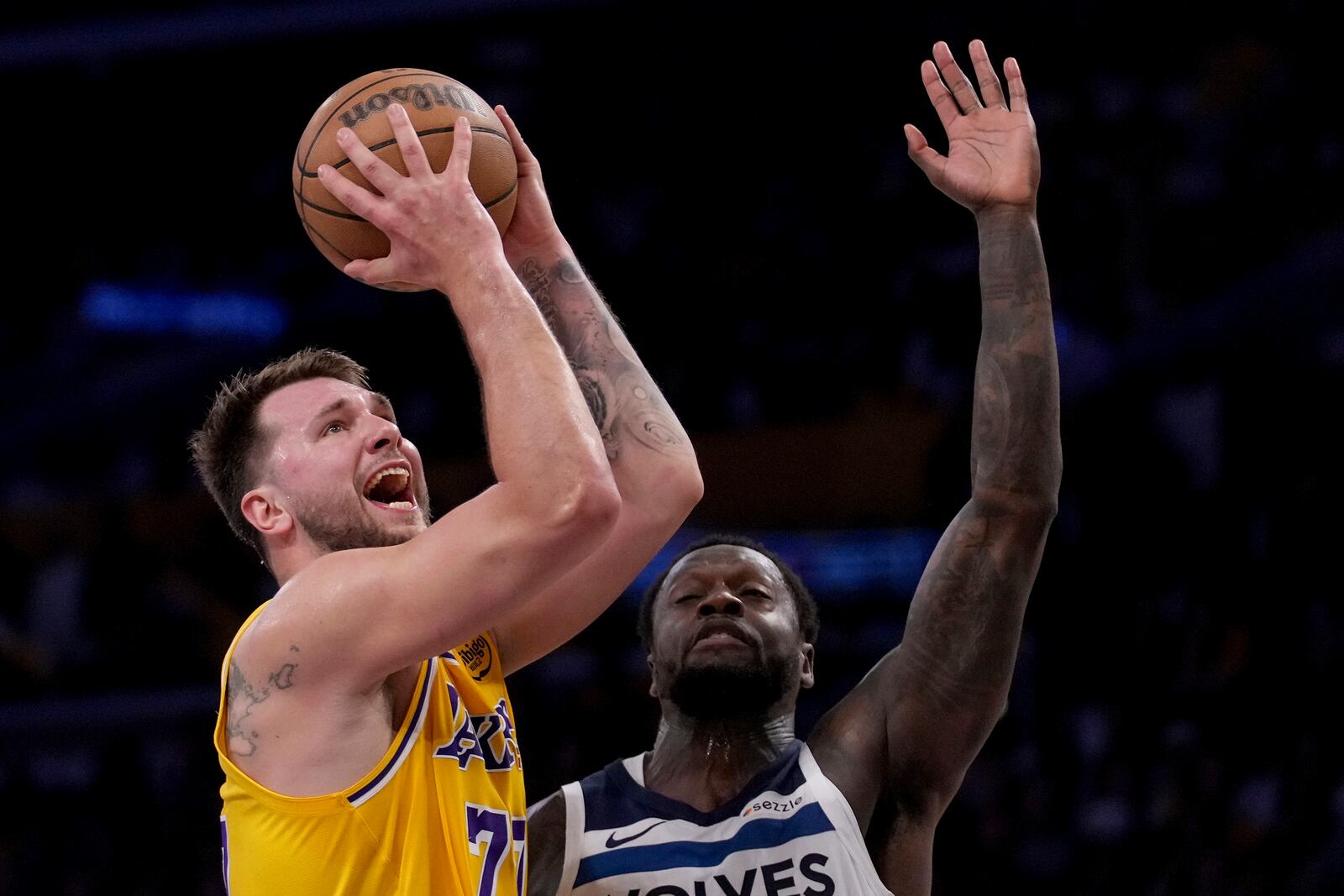 Los Angeles Lakers guard Luka Doncic (77) goes to the basket against Minnesota Timberwolves forward Julius Randle (30) during the first half of Game 2 of an NBA basketball first-round playoff series in Los Angeles, Tuesday, April 22, 2025. (AP Photo/Eric Thayer)