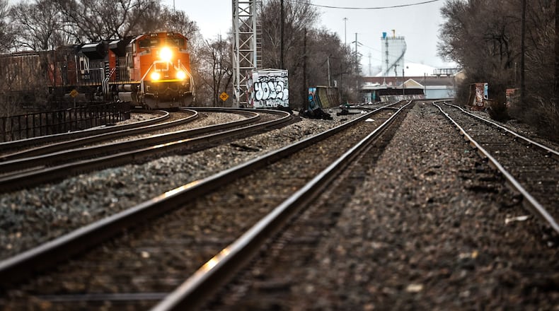 A Canadian National Railway freight train rolls through the heart of Dayton Wednesday February 22, 2023. JIM NOELKER/STAFF
