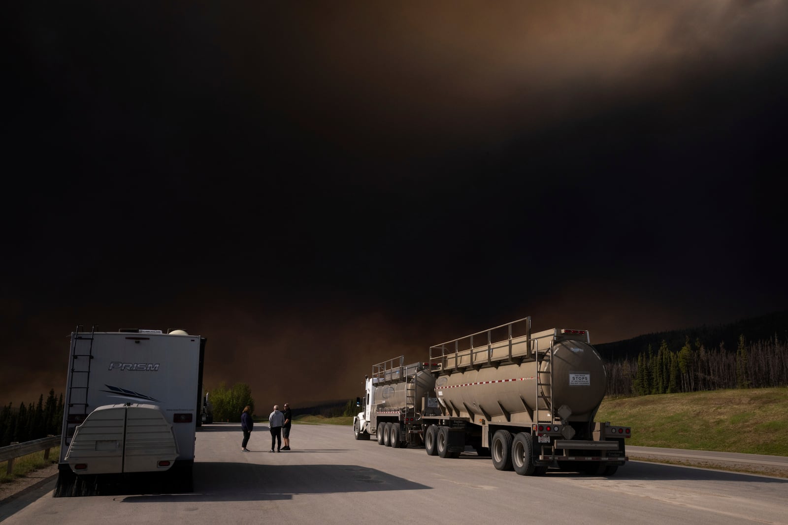 Wildfire smoke hangs in the air above Highway 97 north of Buckinghorse River, British Columbia, on Friday, May 30, 2025. (Nasuna Stuart-Ulin/The Canadian Press via AP)