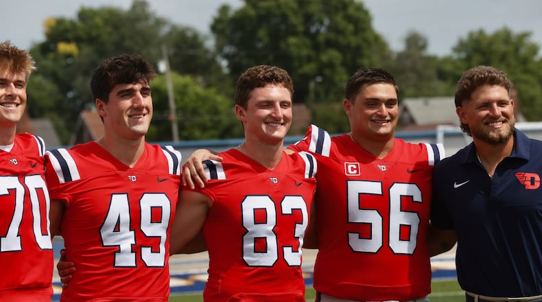 Dayton's Andrew Yanoshak (83) poses for a photo with teammates on Media Day on Sunday, Aug. 17, 2025, at Welcome Stadium. David Jablonski/Staff