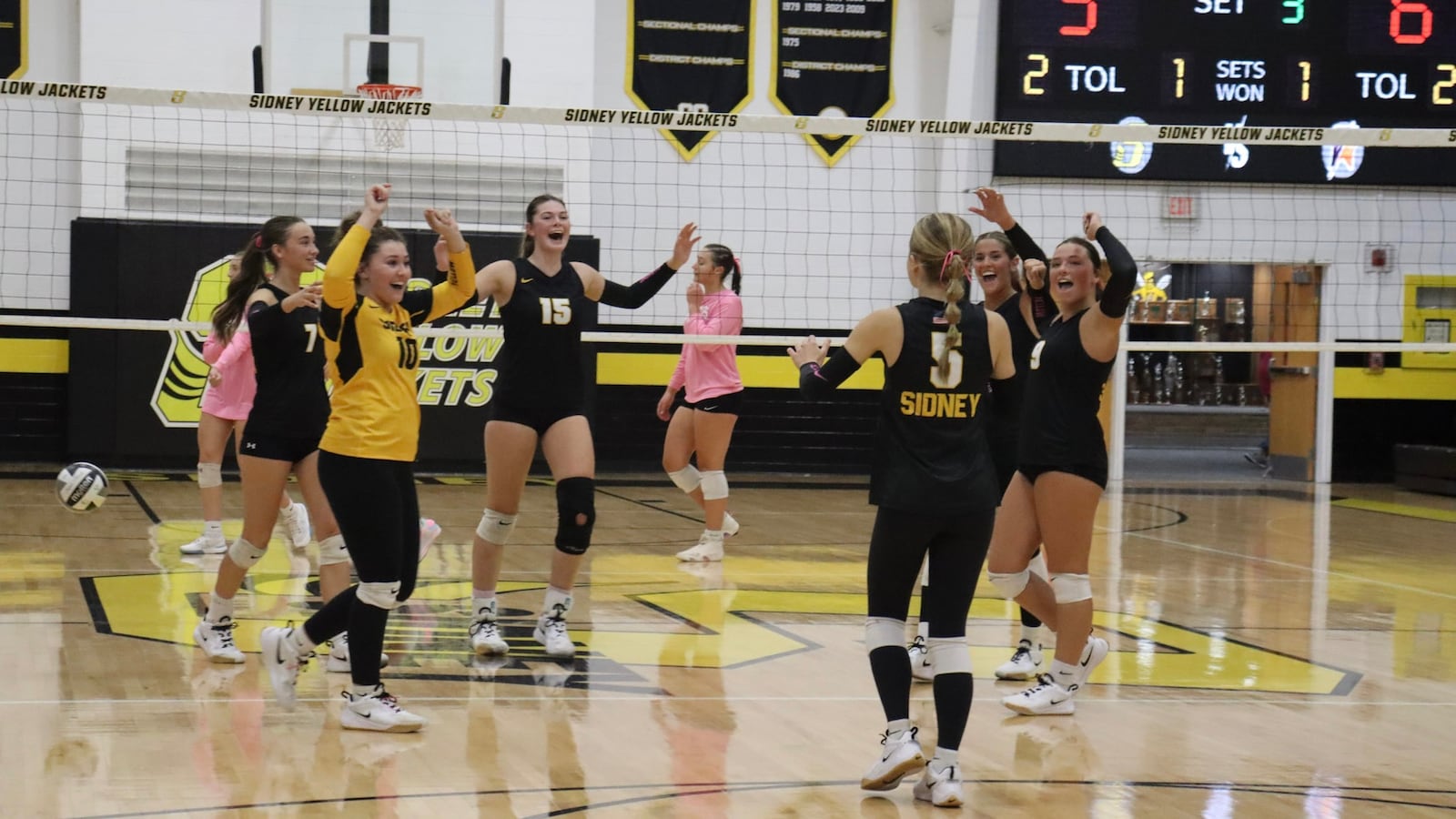 The Sidney girls volleyball team celebrates on the court during a recent game. CONTRIBUTED PHOTO