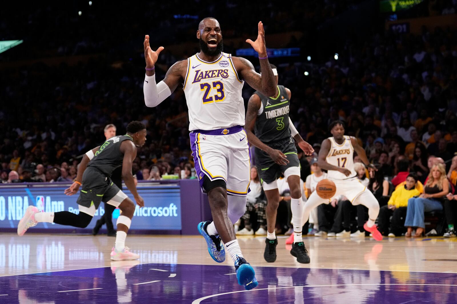 Los Angeles Lakers forward LeBron James, right, reacts after missing a pass during the first half in Game 1 of an NBA first-round playoff series against the Minnesota Timberwolves Saturday, April 19, 2025, in Los Angeles. (AP Photo/Mark J. Terrill)