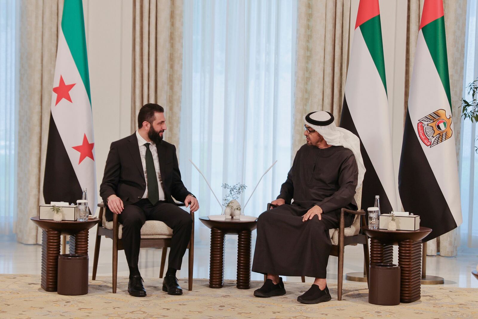 This photo released by the official Syrian news agency SANA, shows United Arab Emirates President Sheikh Mohammed bin Zayed Al Nahyan, right, meeting with Syrian President Ahmad al-Sharaa in Abu Dhabi, United Arab Emirates, Sunday, April 13, 2025. (SANA via AP)