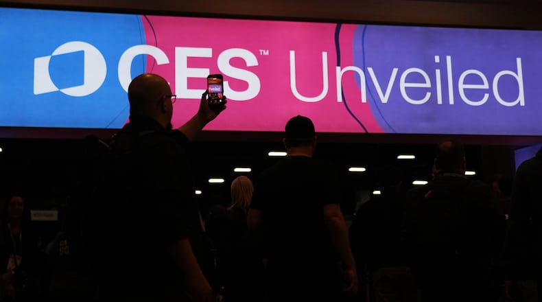 People arrive at the CES Unveiled tech show Sunday, Jan. 4, 2026, in Las Vegas. (AP Photo/Abbie Parr)