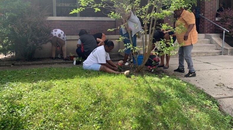 Mercy Manor board members and residents sprucing up the yard at the residential facility. CONTRIBUTED.