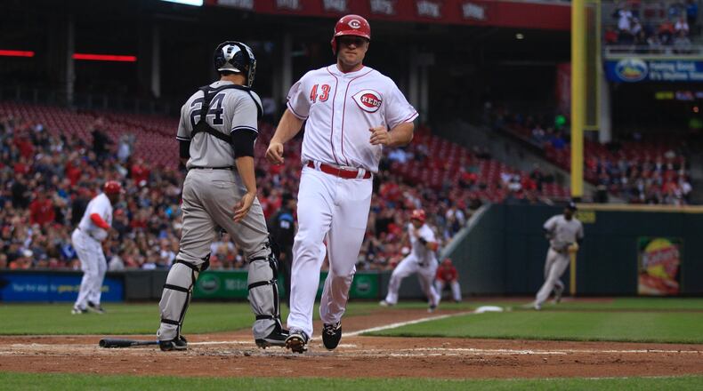 The Reds’ Scott Schebler scores against the Yankees on Tuesday, May 9, 2017, at Great American Ball Park in Cincinnati. David Jablonski/Staff