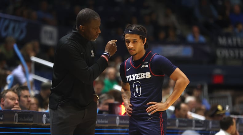 Dayton's Anthony Grant talks to Javon Bennett in the first half of a game against Rhode Island on Wednesday, Feb. 26, 2025, at the Ryan Center in Kingston, R.I. David Jablonski/Staff