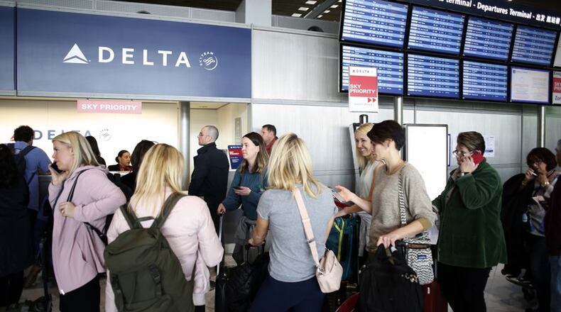Passengers wait in front of the desk of Air France at the Roissy Charles de Gaulle airport, north of Paris, Thursday, March 12, 2020. AP Photo
