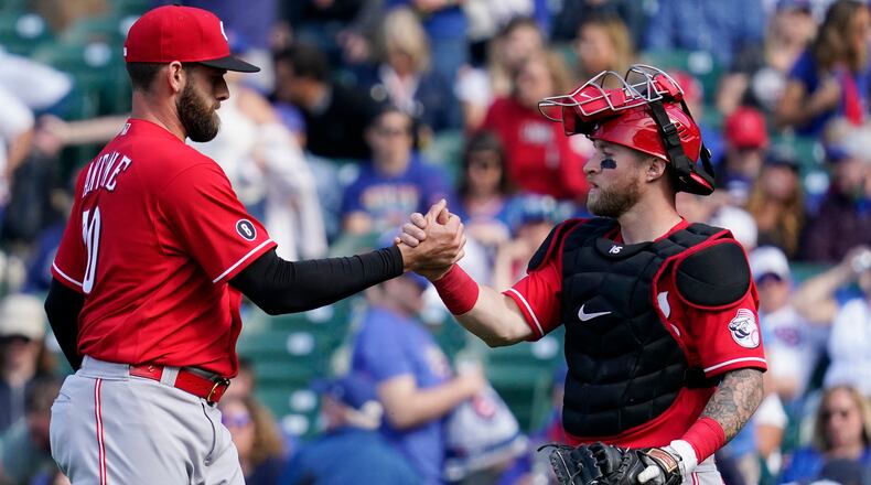 Cincinnati Reds relief pitcher Tejay Antone, left, celebrates with catcher Tucker Barnhart after they defeated the Chicago Cubs in a baseball game in Chicago, Sunday, May 30, 2021. (AP Photo/Nam Y. Huh)