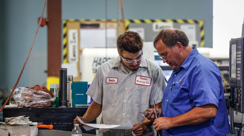 Machinist Dominic Davis, left gets instructions from Detailed Machining President and CEO, John Bertsch at the shop in Sydney Ohio. Bertsch is a hands on leader who works side by side with his employees. JIM NOELKER/STAFF