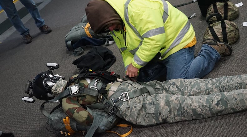 A test dummy is prepared for a ride with RAES, the “Rapid Aerial Extraction System” devised by Beavercreek defense company MTSI Inc. RAES gives a fixed-wing aircraft vertical lift capability to quickly and safely lift and carry downed pilots, proponents say. CONTRIBUTED