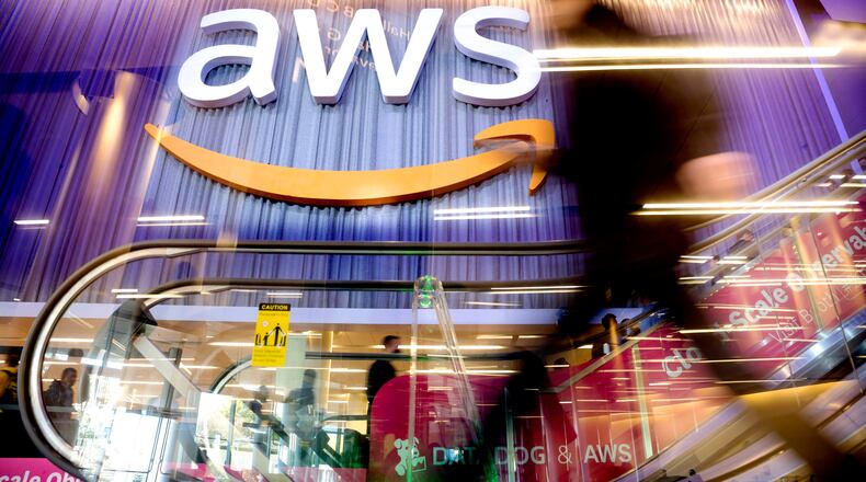 An attendee walks through AWS re:Invent 2022, a conference hosted by Amazon Web Services, on Wednesday, Nov. 30, 2022, in Las Vegas. Ohio Governor Mike DeWine and Lt. Governor Jon Husted announced Monday, June 26, 2023, that Amazon Web Services (AWS) will invest an estimated $7.8 billion by the end of 2029 to expand its data center operations in Central Ohio, creating hundreds of new jobs. (Noah Berger/Amazon Web Services via AP Images)