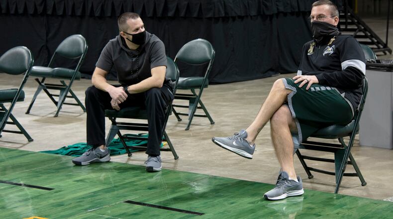 Wright State athletic trainer Jason Franklin (right) and Cole Pittsford, the Raiders' strength and conditioning coach, during practice Friday at the Nutter Center. CONTRIBUTED