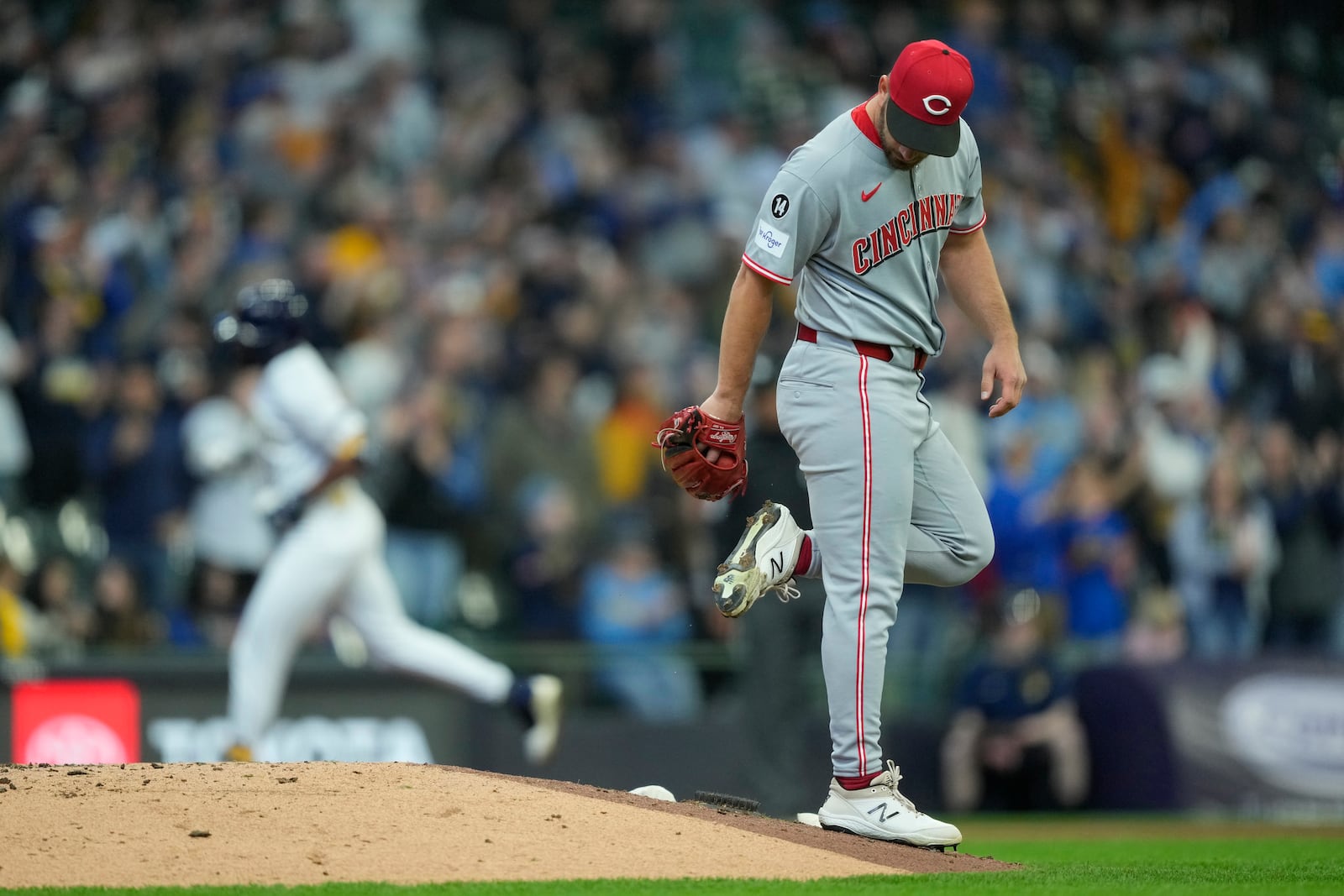 Cincinnati Reds' Sam Moll reacts after giving up a three-run home run to Milwaukee Brewers' Jackson Chourio during the fourth inning of a baseball game Sunday, April 6, 2025, in Milwaukee. (AP Photo/Aaron Gash)