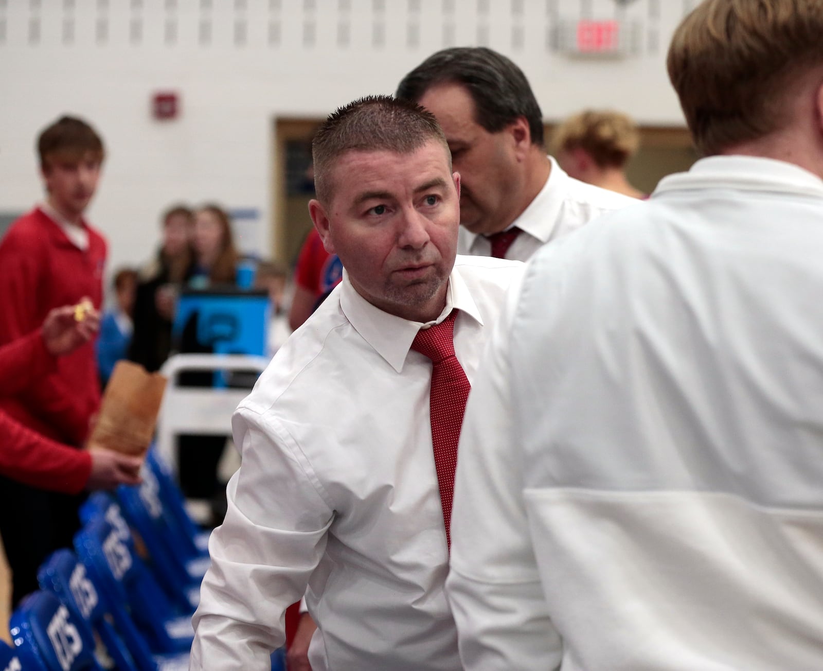 Tri-Village head coach Josh Sagester talks to his assistants after a timeout. Tri-Village defeated Franklin Monroe 58-15 in a Western Ohio Athletic Conference game on Friday, Jan. 23, 2026, in Pitsburg. STEVEN WRIGHT / STAFF