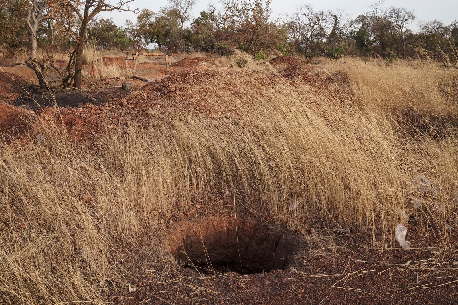 A mining pit sits open and unmarked at a gold mining site in the Kedougou region of Senegal on Thursday, Jan. 16, 2025. (AP Photo/Annika Hammerschlag)
