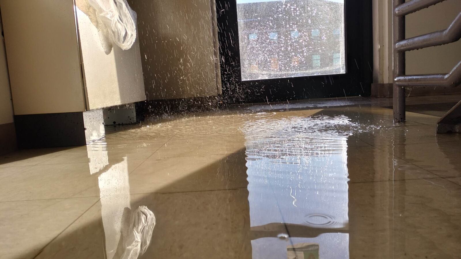 The rear entrance to Building 10 on Wright-Patterson Air Force Base’s Area A floods from a busted water pipe Christmas Day following last month’s winter storm. The storm caused nearly $4 million in damage across both areas of the installation. (U.S. Air Force photo by Matthew Clouse)