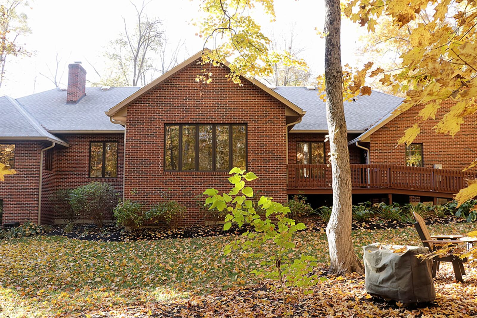 Several tall windows and a glass door fill the 4-season room with natural light. The door opens to the wooden deck and back yard. CONTRIBUTED PHOTO BY KATHY TYLER