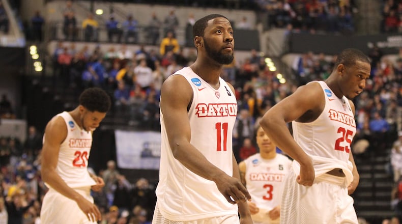 Dayton players, including senior Scoochie Smith, center, leave the court after a loss against Wichita State in the first round of the NCAA tournament on Friday, March 17, 2017, at Bankers Life Fieldhouse in Indianapolis. David Jablonski/Staff