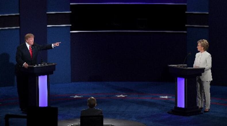 Republican presidential nominee Donald Trump (L) speaks as Democratic presidential nominee former Secretary of State Hillary Clinton looks on during the third U.S. presidential debate at the Thomas & Mack Center on Oct. 19, 2016, in Las Vegas, Nevada. (Photo by Ethan Miller/Getty Images)