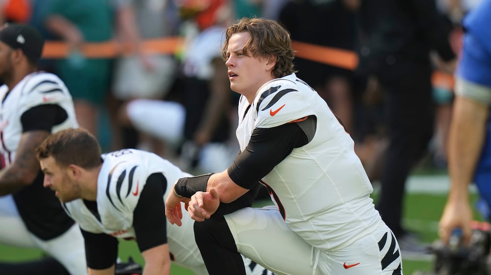 Cincinnati Bengals quarterback Joe Burrow stretches during pregame warmups before an NFL football game against the Miami Dolphins, Sunday, Dec. 21, 2025, in Miami Gardens, Fla. (AP Photo/Lynne Sladky)