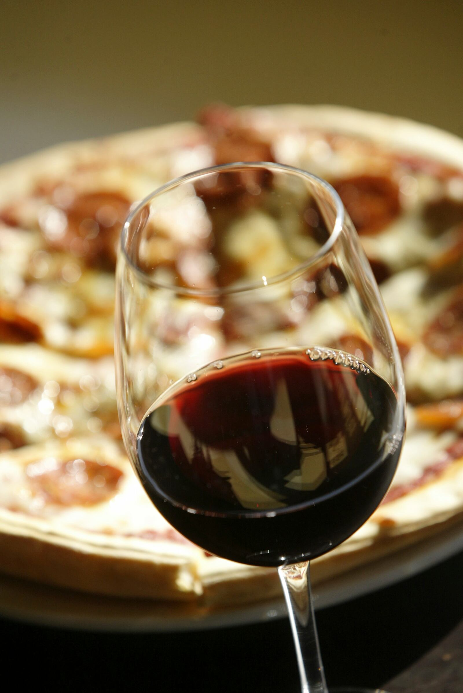 A glass of Raimet Tempranillo paired with a pepperoni pizza at The Wine Gallery & Cafe, 424 East Third St., Dayton. Staff photo by Chris Stewart