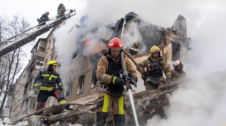 Firefighters put out the fire in the ruins of an apartment building following Russia's missile attack in Kharkiv, Ukraine, Saturday, March 7, 2026. (AP Photo/Andrii Marienko)